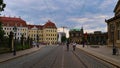 Cobbled street SophienstraÃÅ¸e in southern direction with tramway, cycling tourists and building complex Zwinger.